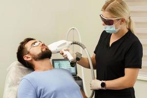 Man during beard photoepilation procedure photo