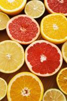 Different sliced citrus fruits such as grapefruit, orange, lemon and lime photo