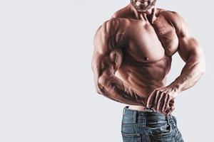 Muscular man bodybuilder wearing jeans photo