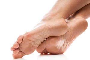 Female heels with dead skin against white background photo