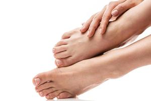 Female feet and hands with soft skin, french manicure and pedicure on white background photo