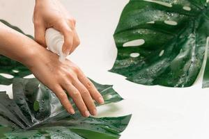 Woman is applying cleansing foam on her hand photo