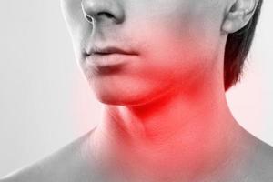 Man with a pain in his neck. Concepts of problems with thyroid or sore throat. photo