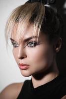 Fashion model with a creative makeup and hairstyle photo