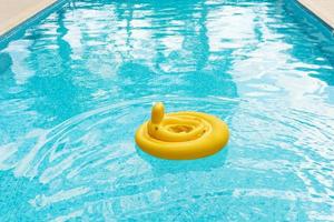 Inflatable baby float ring in open-air swimming pool photo