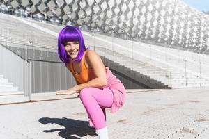Carefree active woman dancer wearing colorful sportswear having fun on the street photo