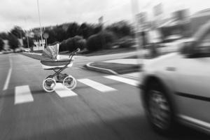 Car accident on the crosswalk. Vehicle hits the baby pram at high speed. photo