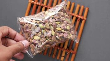 nantural pistachios nut in a plastic packet on wood video
