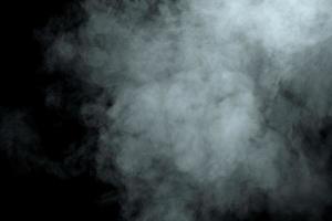 Abstract  powder or smoke isolated on black background photo