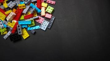 Plastic toy block on a black background photo