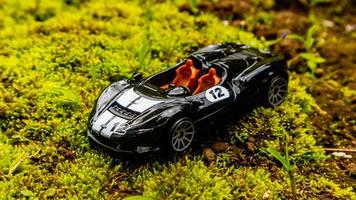 Minahasa, Indonesia  saturday, 10 December 2022, a toy car on green mossy ground