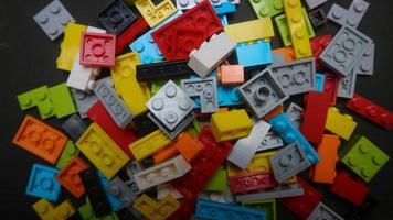 Plastic toy block on a black background photo