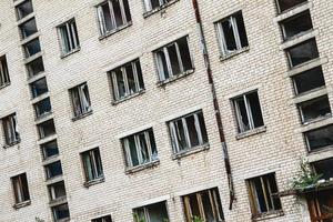 Exterior of abandoned apartment building in european ghost town. photo