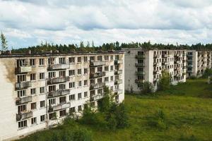 Exterior of abandoned apartment buildings in european ghost town. photo