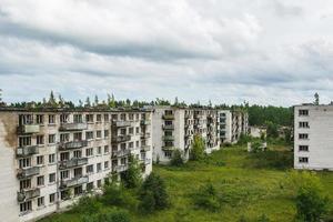 Exterior of abandoned apartment buildings in european ghost town. photo