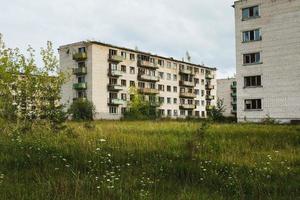 Exterior of abandoned apartment buildings in european ghost town. photo