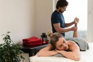 mujer durante el masaje de pies en un salón de masajes profesional