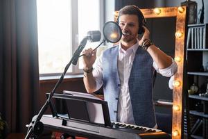 Young man is singing in a studio photo