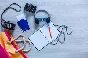 Flat lay traveler accessories on yellow background with blank space for text. Top view travel or vacation concept. Summer background photo