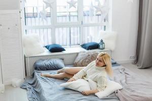 Relaxed young woman lying on couch photo