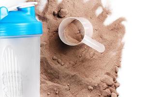 Shaker, scoop and chocolate whey protein or mass gainer powder photo