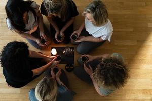 Women friends holding cups of hot tea. photo