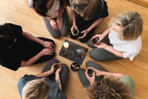 Women friends holding cups of hot tea. photo