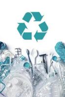 Pile of plastic waste and recycling symbol photo
