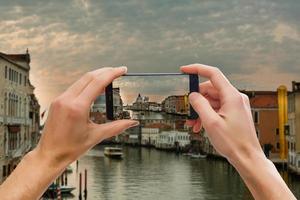 Traveler tourist taking beautiful landscape photo of european sunset during holiday vacation