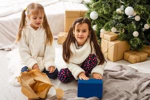 Two little girls in Christmas background photo