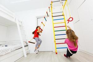 Two cute little girls playing role game in daycare photo