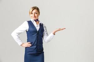 Portrait of charming stewardess wearing in blue uniform. Isolated on white background photo