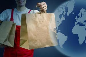 Diverse of paper containers for takeaway food. Delivery man is carrying photo