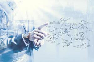 Business man pointing at growth graph and business concept. investment, business, future technology and money concept - closeup of man hand pointing at chart. photo