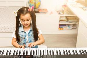 girl long hair practicing piano photo