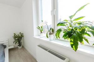 White bedroom with brick elements, balcony, double bed, photo