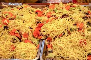 Top view and closeup of vegan Chinese yellow noodle for sell in food market photo