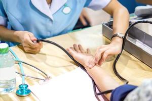 Image of the nurse's hand is measuring the pulse. And patient pressure. photo