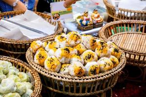 Closeup Chinese pastry moon cake sell in food market for Chinese new year, made with flour filling Most of them are clover with many sizes and is a dessert of luck in Chinese new year. photo