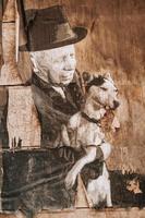 picture poster on the wall of a man with a dog in the old school style. photo