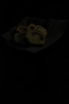 cake in a banana leaf container on a black background photo