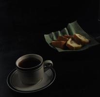 tea and cake on black background. Tea Time at home concept. photo