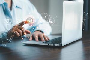 Businesswoman using laptop and touching on virtual screen contact icons such as email, address, live chat, internet wifi.Contact us or Customer support hotline people connect. Connect with cyberspace. photo