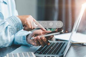 Businesswoman using phone and touching on virtual screen contact icons such as email, address, live chat, internet wifi. Contact us or Customer support hotline people connect. Connect with cyberspace. photo