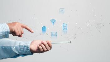 Businesswoman using phone and touching on virtual screen contact icons such as email, address, live chat, internet wifi. Contact us or Customer support hotline people connect. Connect with cyberspace. photo