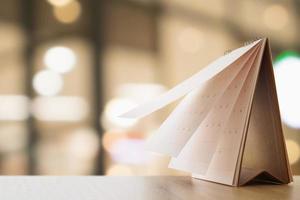 desk calendar on table with blurred bokeh background appointment and business meeting concept photo