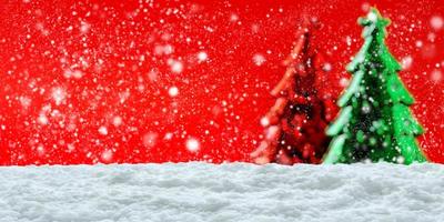 Empty white snow with blur Christmas tree background photo