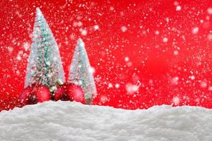 Empty white snow with blur Christmas tree background photo