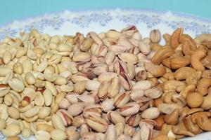 Different dried fruits and nuts on white background, top view. Space for text photo