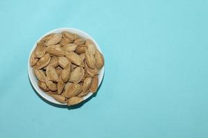 Different dried fruits and nuts on white background, top view. Space for text photo
